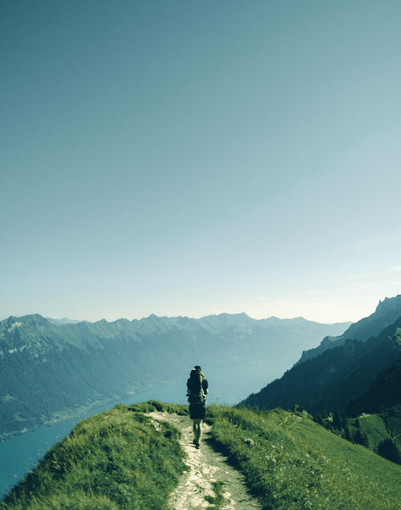 a man with a backpack on a mountain trail